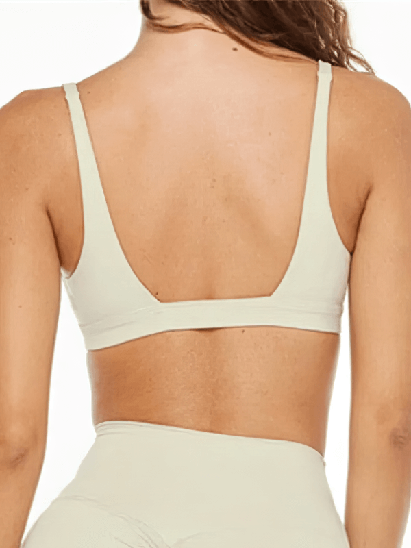Back view of women's quick-drying sports bra in nylon, deep neckline, ideal for yoga or workouts, breathable material, solid pattern.